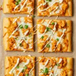 Buffalo chicken flatbread with melted cheese, chicken, and blue cheese drizzle