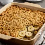 Southern banana cobbler with golden streusel topping and banana slices