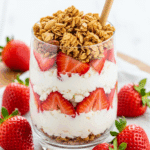 Strawberry cheesecake breakfast parfait with cottage cheese, strawberries, and granola layers