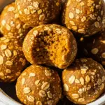 Pumpkin protein balls in white bowl showing golden color and healthy texture