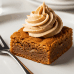 Plated brown butter blondie with speculoos buttercream and coffee background