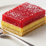 Plated cranberry curd bar showing red curd layer over golden shortbread